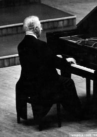 Plano general de Arthur Rubinstein de espaldas sentado al piano