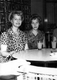 Portada:Plano medio de Aniela Rubinstein, Alina Rubinstein, Esther Rubin y una mujer posando sentadas en una mesa
