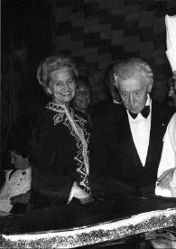 Portada:Plano medio de Aniela Rubinstein, Arthur Rubinstein, un cocinero y un hombre admirando una tarta con forma de piano de cola negro